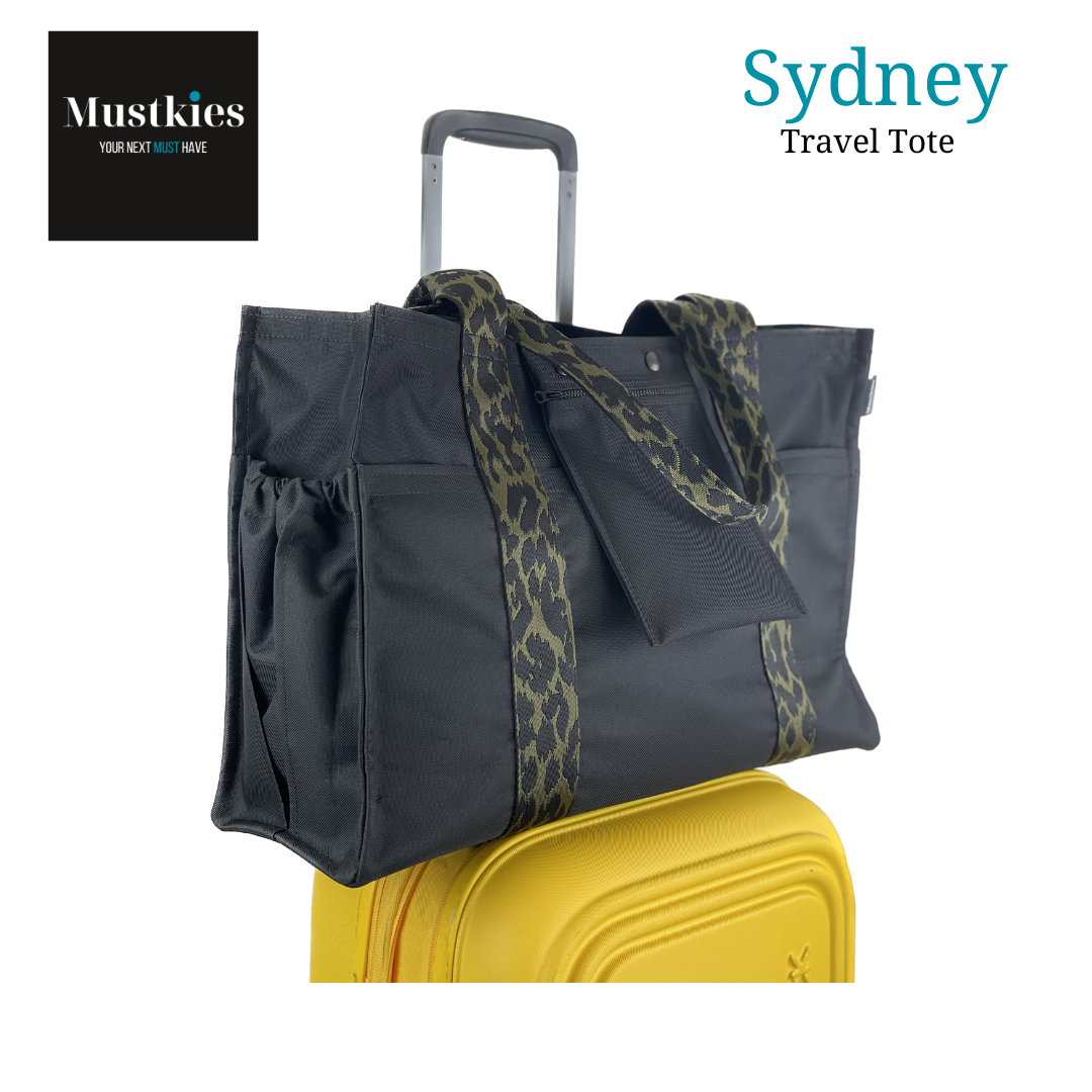 Mustkies Travel + Leisure tote with 8 interior pockets,  Travel Sleeve and detachable pouch. Slides over the handel of your luggage making it super convenient.