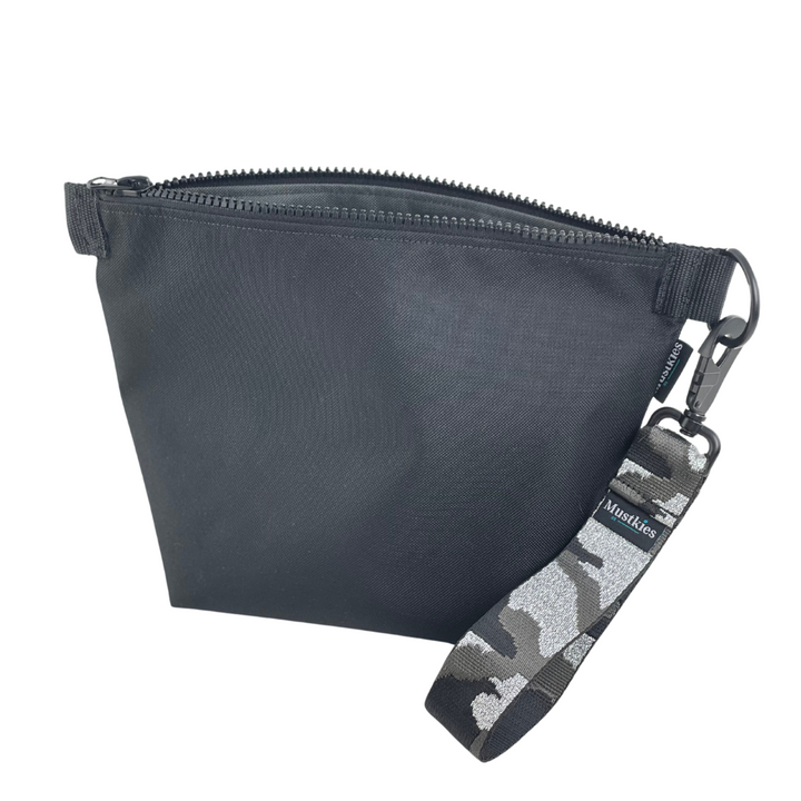 Lets go out in style! Black and Gray clutch with a camouflage wristlet. The Voyage clutch from Mustkies, a versatile accessory perfect for both cosmetic storage and everyday use as a daytime carry clutch. Handmade in a waterproof canvas inside and out. 