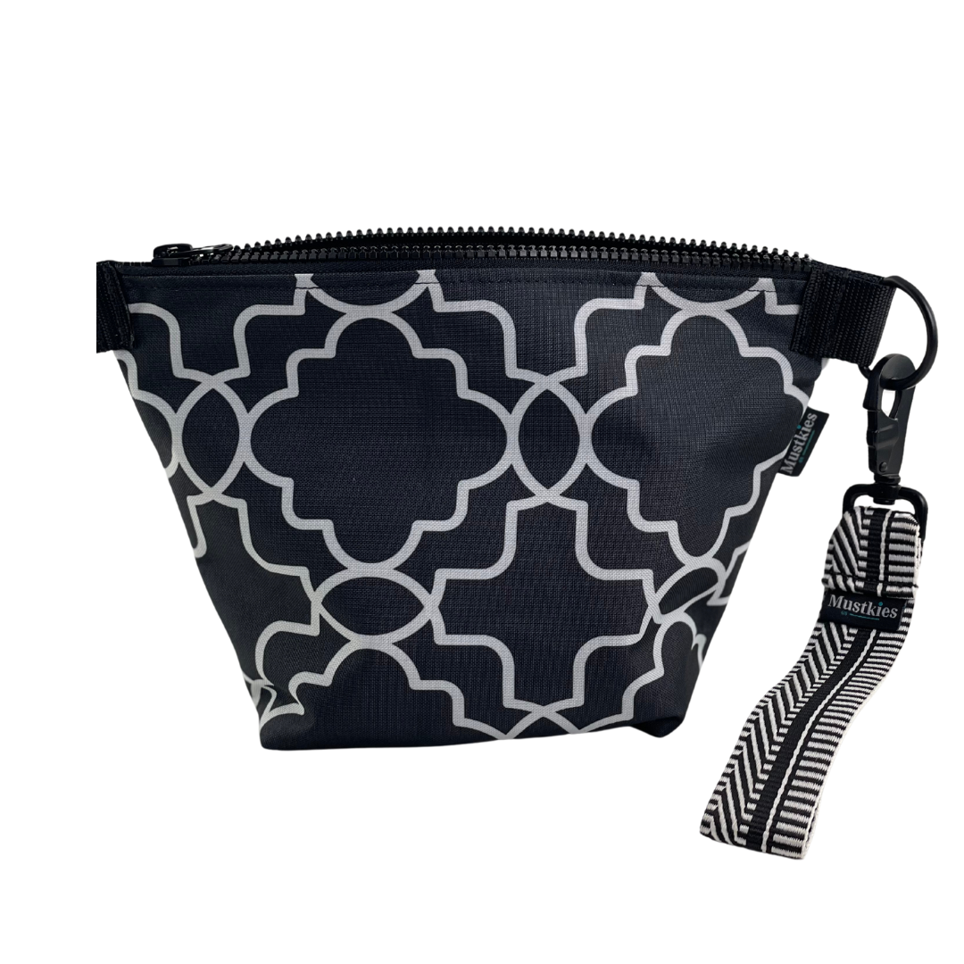 A versatile accessory perfect for both cosmetic storage and everyday carry. Handmade in a waterproof canvas inside and out. Print is a floral white design with black & white wristlet straps.