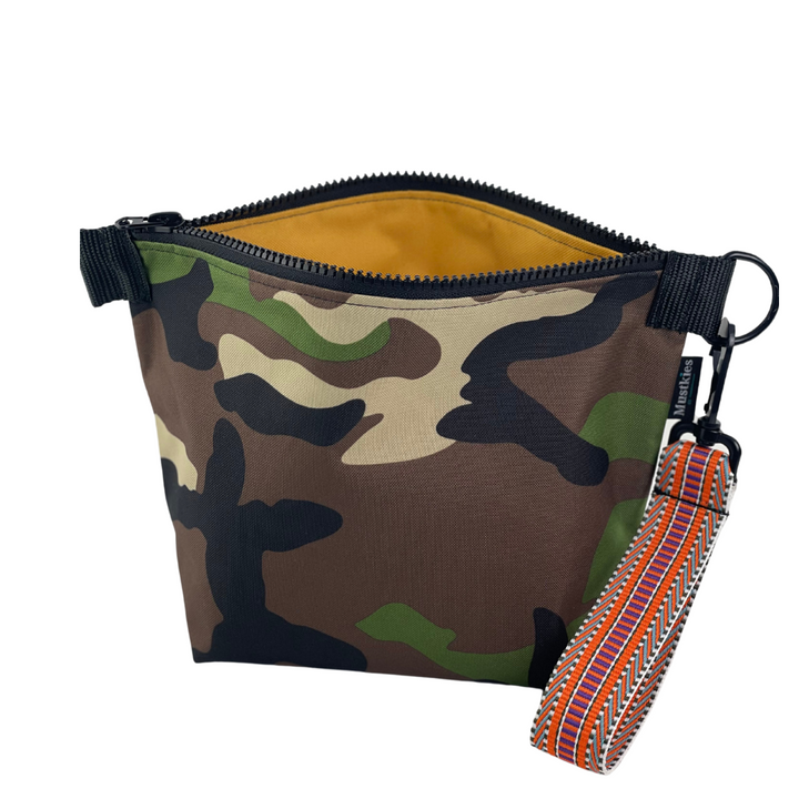 Everyone love camouflage!!! This is Mustkies Voyage clutch. A versatile accessory perfect for both cosmetic storage and everyday use as a daytime carry clutch. Handmade in a waterproof canvas inside and out.