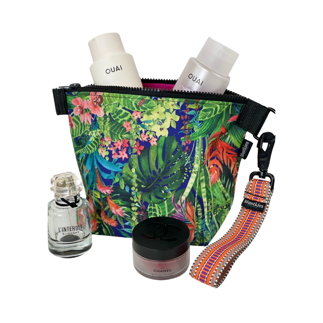 The Voyage clutch from Mustkies, a versatile accessory perfect for both cosmetic storage and everyday use as a daytime carry clutch. Handmade in a waterproof canvas inside and out. Print is a floral design with colorful wristlet straps.