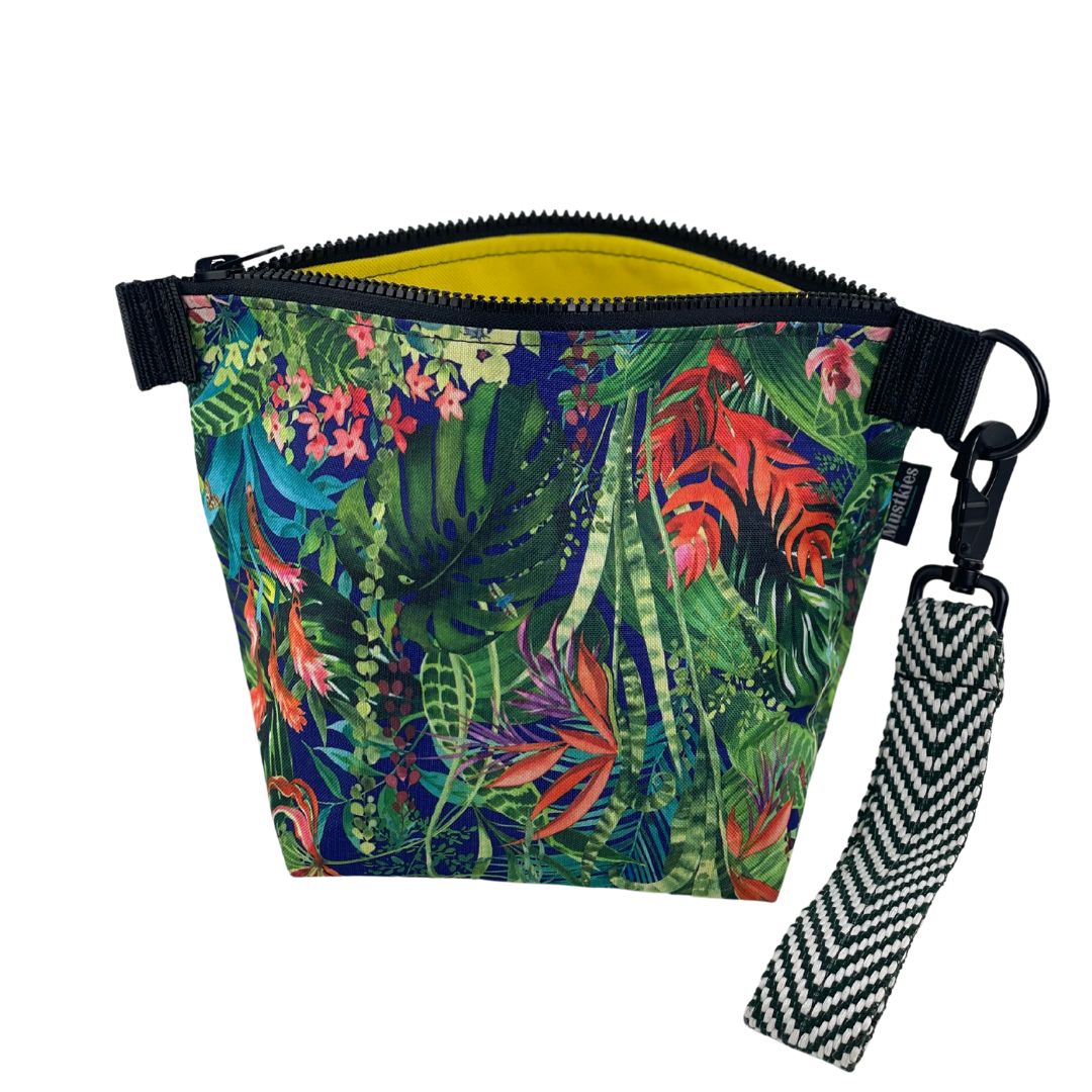 This screams vacation and beach time! Beautiful  jungle print print on Mustkies Voyage clutch. A versatile accessory perfect for both cosmetic storage and everyday use as a daytime carry clutch. Handmade in a waterproof canvas inside and out.