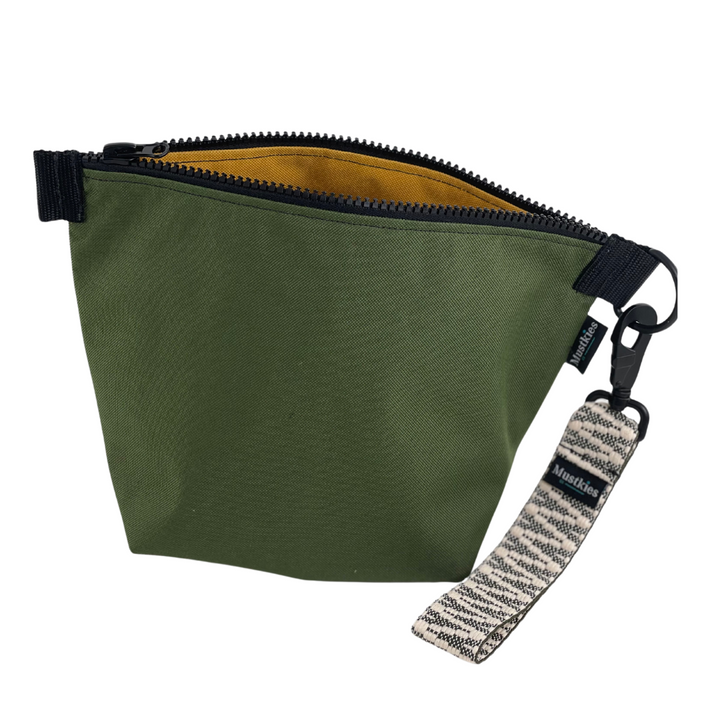 Green is the easiest color to wear winter or summer. Mustkies Voyage clutch is your everyday carry. Handmade in a green waterproof canvas on the outside and a mustard inside fabric.