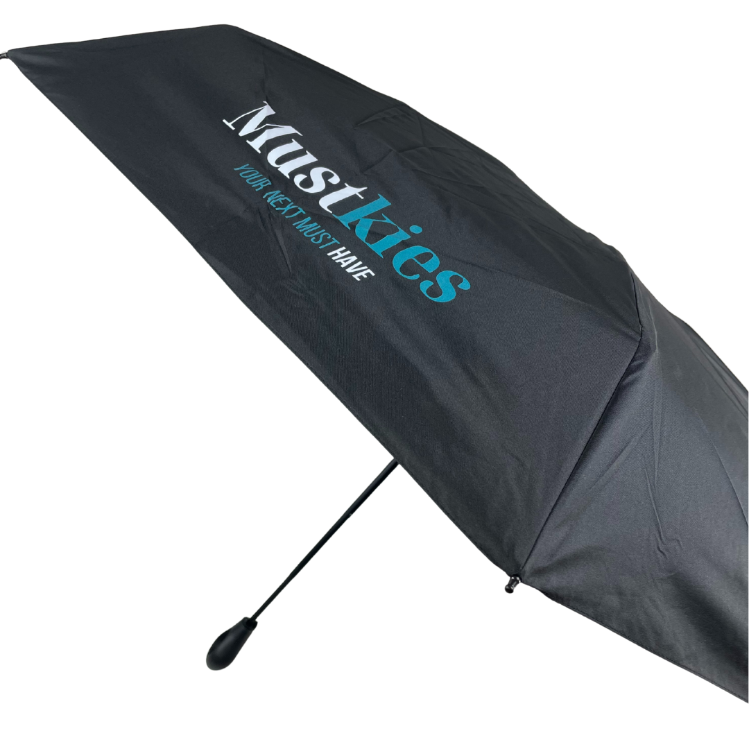 Black umbrella with 'Mustkies' branding on a white background