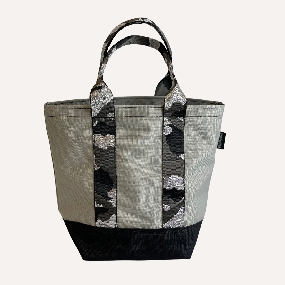 Mustkies LENA Handmade shopper tote for both adults and kids. Crafted in a gray waterproof canvas, finished in a gray camouflage strap. Great for looking stylish and going shopping with mommy/daddy and friends! Lots of room for your accessories and more. Three inside pockets and 1 mask/key holder. 