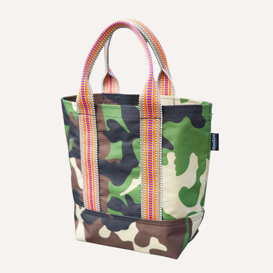 Mustkies LENA Handmade shopper tote for both adults and kids. Crafted in a green camouflage waterproof canvas. Great for looking stylish and going shopping with mommy/daddy and friends! Lots of room for your accessories and more. Three inside pockets and 1 mask/key holder. Holds against all types of wear and tear and perfect for all types of indoor and outdoor use. The Tote bag is 7.5"L x 5.5 W x 10" Tall. 5" drop. White Plains NY Small Women Owned Business. Westchester County